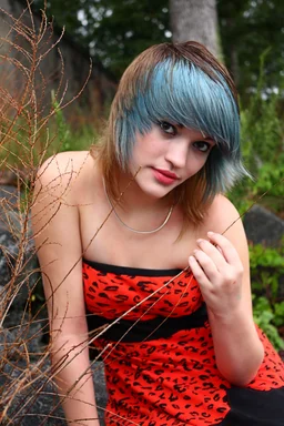 Free Stock Photo: A beautiful young woman posing in a red dress on rocks