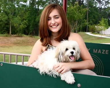 Free Stock Photo: A beautiful young girl playing on a playground with a dog