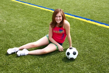 Free Stock Photo: A cute young girl posing with a soccer ball