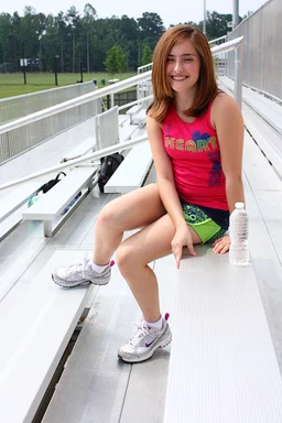 Free Stock Photo: A cute young girl posing outdoors on bleachers