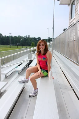 Free Stock Photo: A cute young girl posing outdoors on bleachers