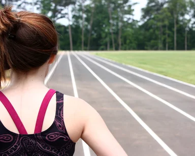 Free Stock Photo: A cute young girl on a track field
