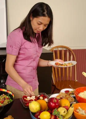 Free Stock Photo: A young Asian woman serving herself food from a table