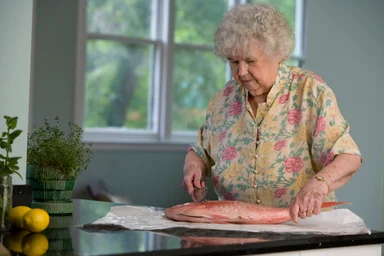 Free Stock Photo: An elderly woman preparing fresh fish