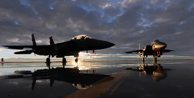 Free Stock Photo: Two F-15E fighter jets on a runway with a sunset
