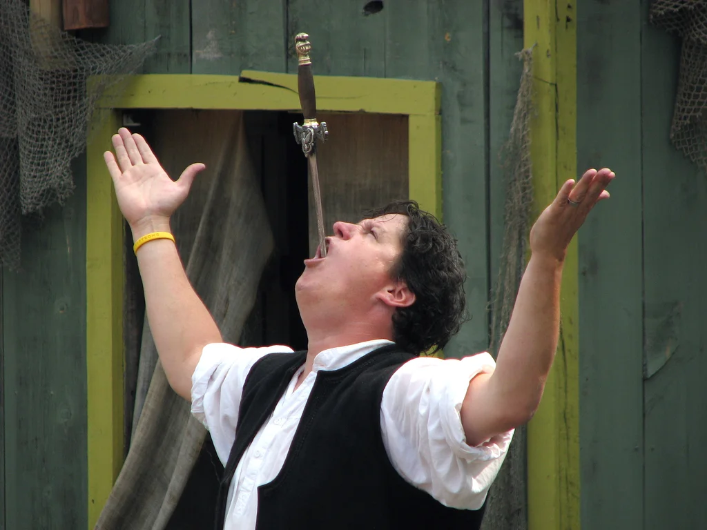 Sword swallower with a sword in his mouth : Free Stock Photo