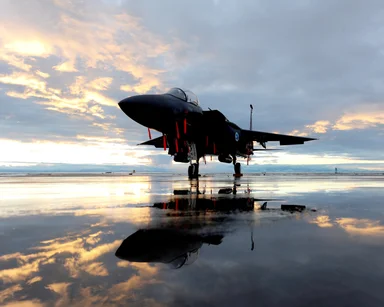 Free Stock Photo: An F-15E fighter jet on a runway at sunset