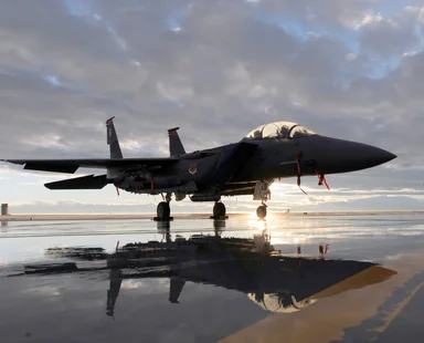 Free Stock Photo: An F-15E fighter jet on a runway at sunset