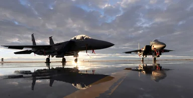 Free Stock Photo: Two F-15E fighter jets on a runway at sunset