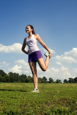 Free Stock Photo: A young woman stretching outdoors before exercising