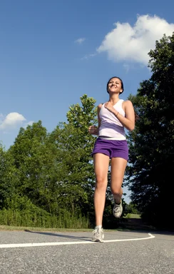 Free Stock Photo: A young woman jogging outdoors