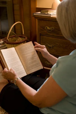 Free Stock Photo: A woman reading a book in her home