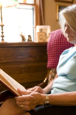 Free Stock Photo: A woman reading a book in her home