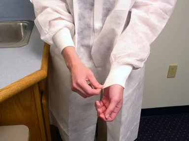 Free Stock Photo: A lab technician putting on disposable gloves