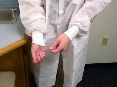 Free Stock Photo: A lab technician preparing to put on disposable gloves
