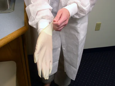 Free Stock Photo: A lab technician putting on disposable gloves