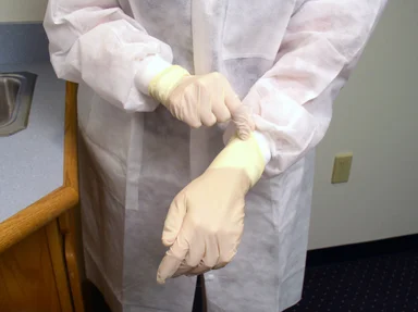 Free Stock Photo: A lab technician putting on disposable gloves