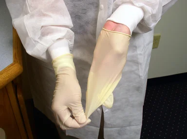 Free Stock Photo: A lab technician pulling off disposable gloves
