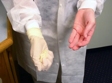 Free Stock Photo: A lab technician pulling off disposable gloves