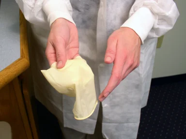 Free Stock Photo: A lab technician pulling off disposable gloves