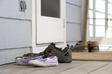 Free Stock Photo: Pairs of shoes on a door mat
