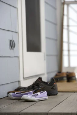 Free Stock Photo: Pairs of shoes on a door mat