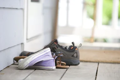 Free Stock Photo: Pairs of shoes on a door mat