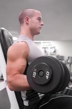 Free Stock Photo: A healthy young man lifting weights in a gym