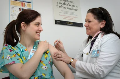 Free Stock Photo: A woman receiving a vaccination shot from her doctor