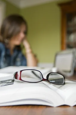 Free Stock Photo: A pair of glasses with an open book