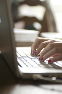Free Stock Photo: Female hands typing on a laptop keyboard