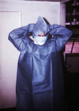Free Stock Photo: A doctor putting on a gown