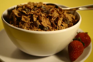 Free Stock Photo: A bowl of cereal with raisins and strawberries