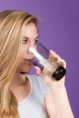 Free Stock Photo: A young woman sipping from a glass of water