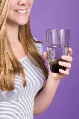 Free Stock Photo: A young woman holding a glass of water