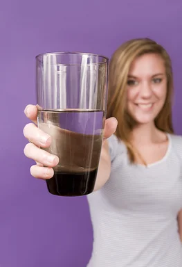 Free Stock Photo: A young woman holding a glass of water