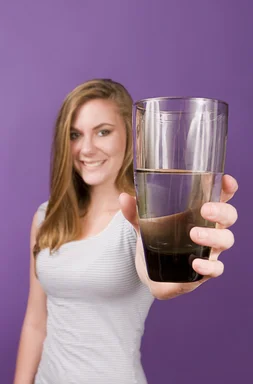 Free Stock Photo: A young woman holding a glass of water