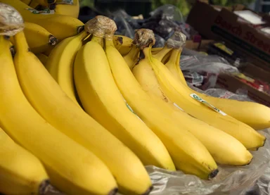 Free Stock Photo: A bunch of yellow bananas on display in a market