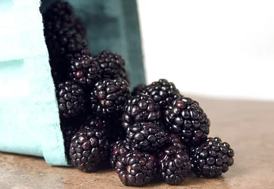 Free Stock Photo: A container of spilled blackberries