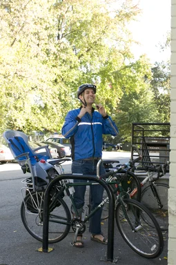 Free Stock Photo: A bicyclist putting on a safety helmet