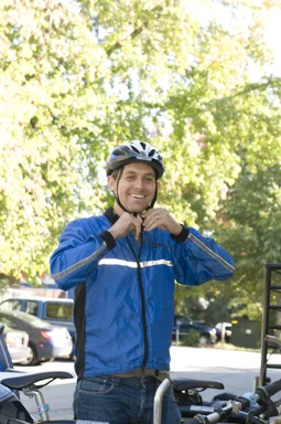 Free Stock Photo: A bicyclist putting on a safety helmet