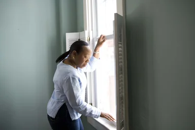 Free Stock Photo: An African-American woman cleaning a window