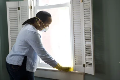 Free Stock Photo: An African-American woman cleaning a window