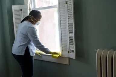 Free Stock Photo: An African-American woman cleaning a window