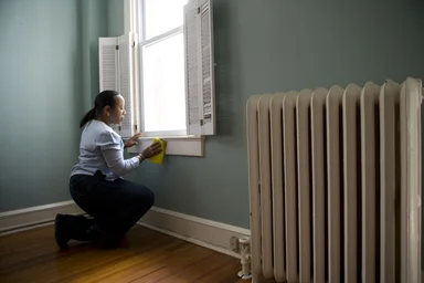 Free Stock Photo: An African-American woman cleaning a window
