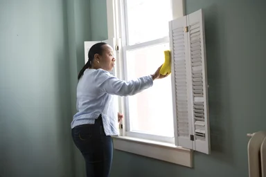 Free Stock Photo: An African-American woman cleaning a window