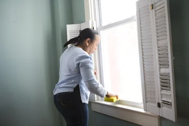 Free Stock Photo: An African-American woman cleaning a window