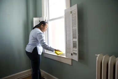 Free Stock Photo: An African-American woman cleaning a window