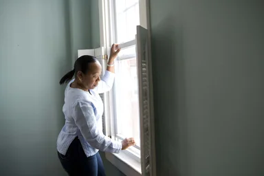 Free Stock Photo: An African-American woman cleaning a window