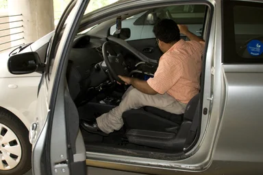 Free Stock Photo: A man in a wheelchair getting out of a car